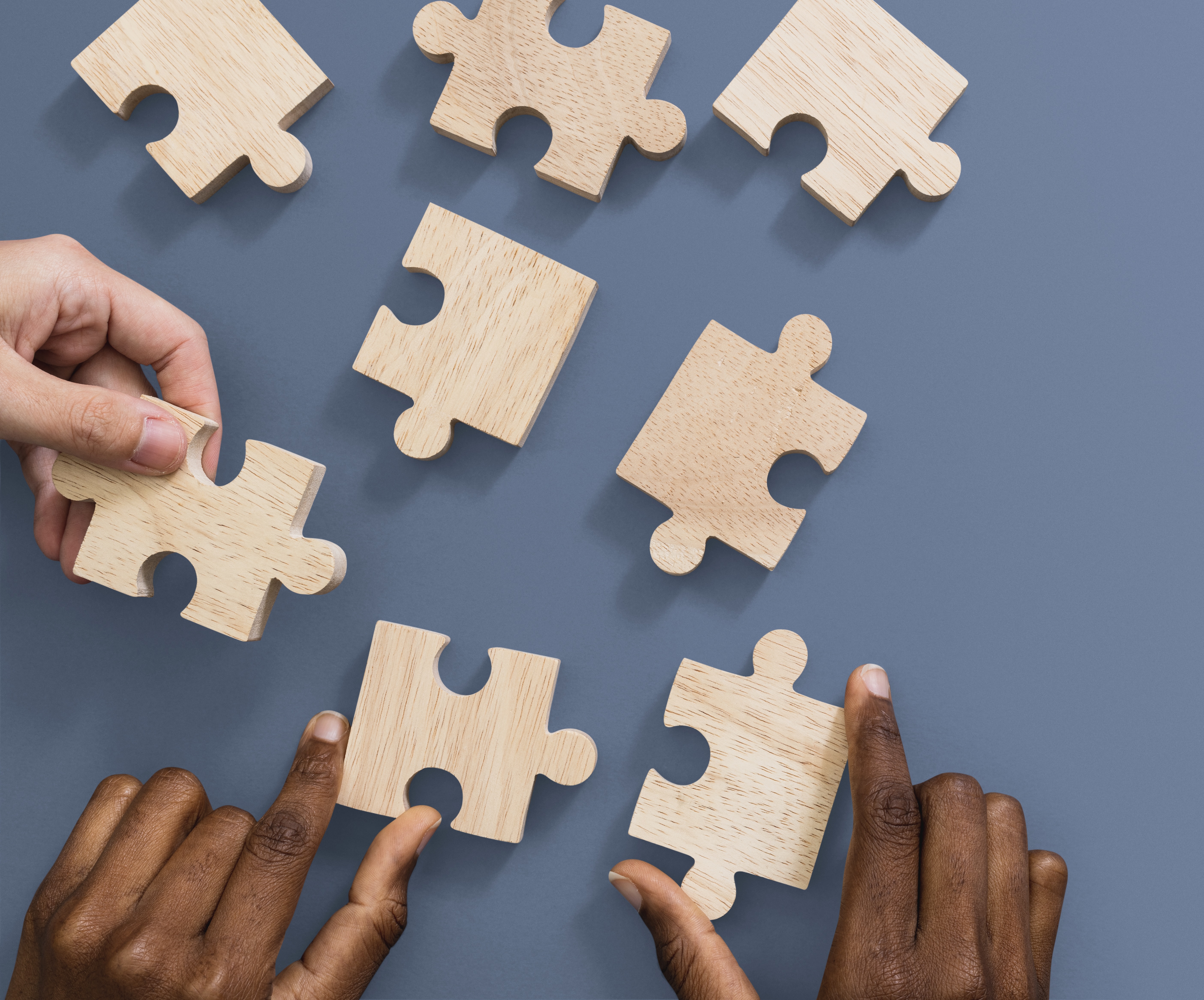 Hands holding puzzle business problem solving concept